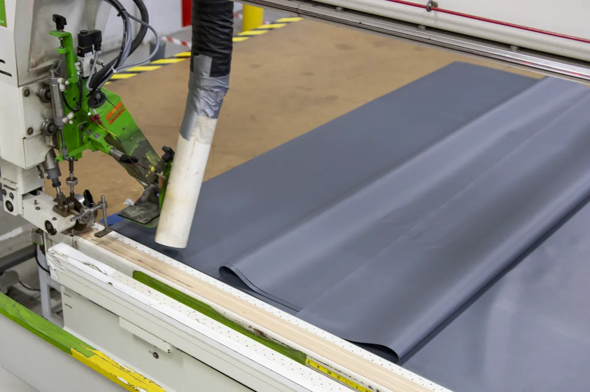 Integra heat-seal welding machine bonding Aegis fabric — heat-sealed webbing process at Knoxville manufacturing facility