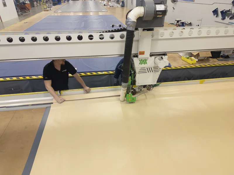 Worker operating heat-seal welding machine at Integra factory — Knoxville Tennessee